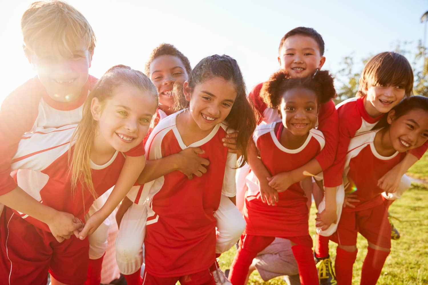 youth soccer team smiling together showing teamwork and support